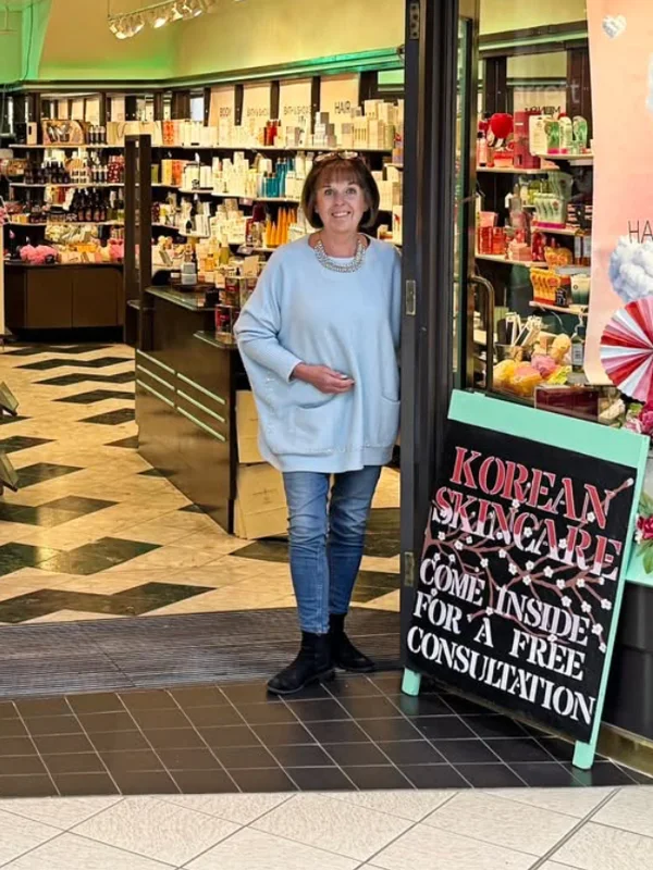 Suzy, founder of The Natural Body Co, standing in the shop doorway